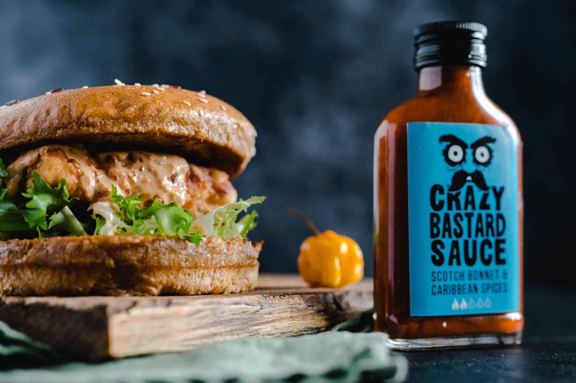 Bold Scotch Bonnet chili sauce infused with Caribbean spices, handcrafted in the UK, great for marinades, grilling, and spicy dishes.