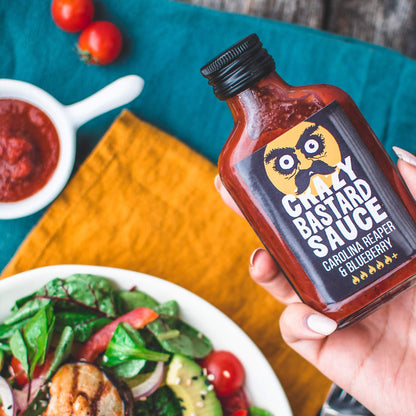 Extra-hot Carolina Reaper chilli sauce with intense heat and smoky flavor, ideal for spicy food lovers. Handcrafted, vegan, and gluten-free sauce made in the UK.